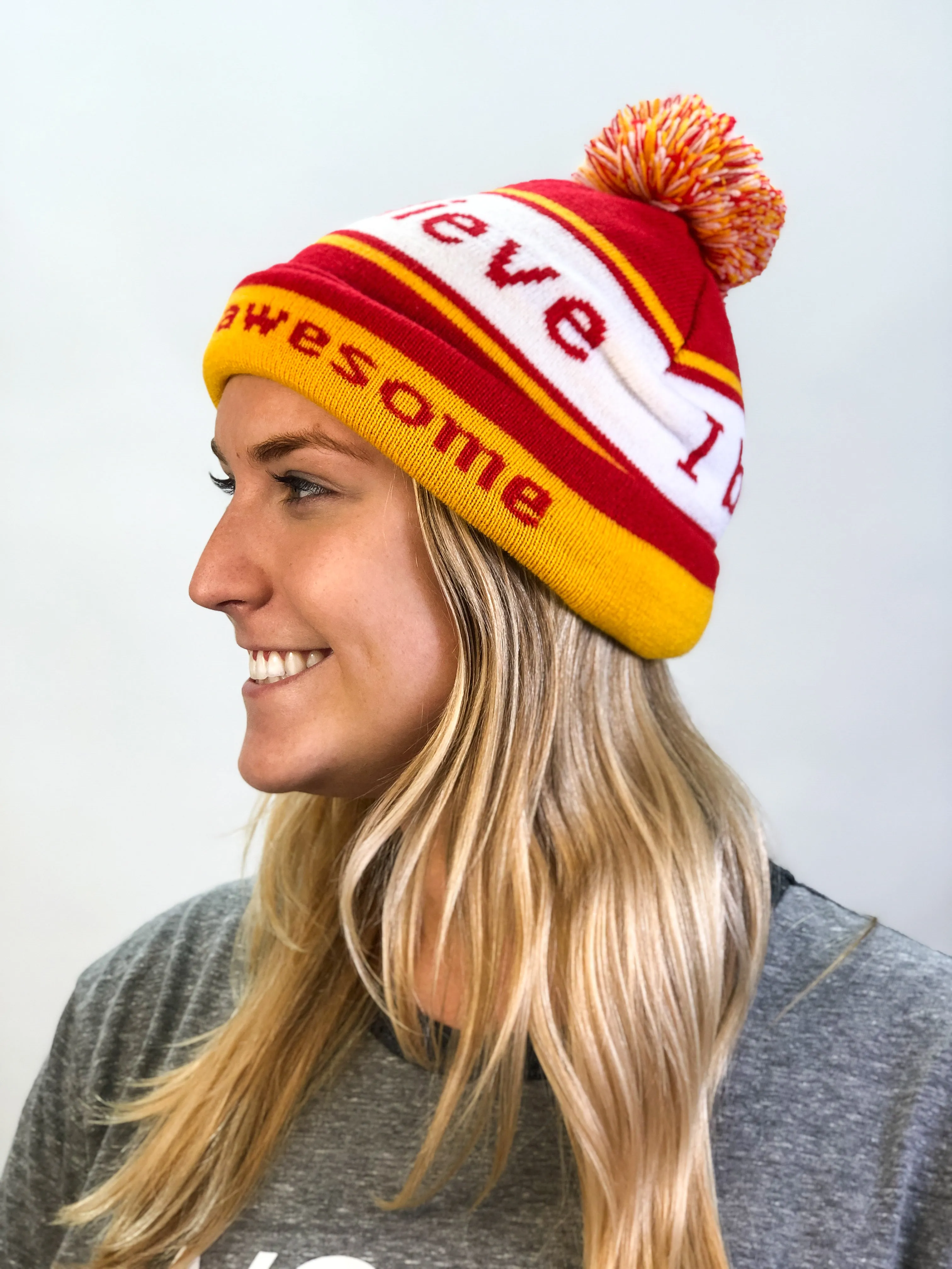 I believe™ red & gold knit beanie with We are awesome™ on inside cuff